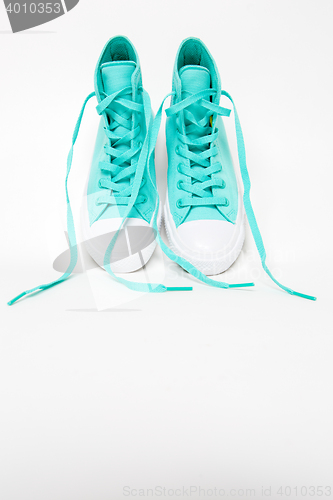 Image of Pair of shoes with long laces untied