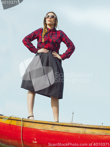 Image of fashionable young model posing with trendy clothes