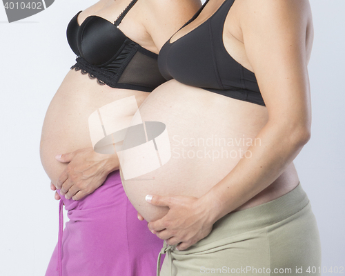 Image of Pregnant Women holding her hands on beautiful belly