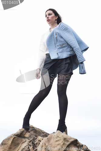 Image of fashionable young model posing with trendy clothes