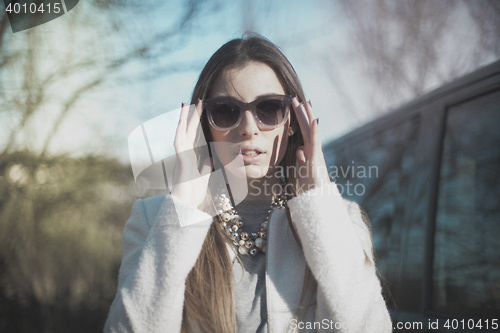 Image of fashionable young model posing with trendy clothes