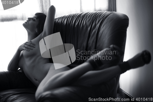Image of attractive erotic female body in couch
