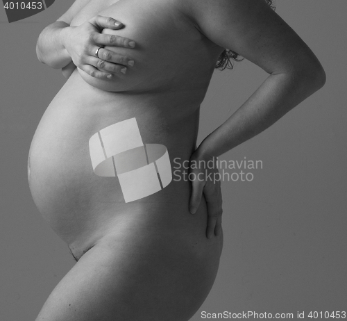 Image of Pregnant Woman holding her hands on beautiful belly