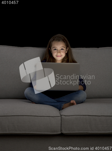 Image of Little girl working with a laptop