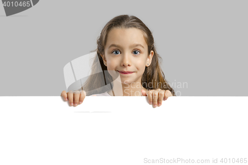 Image of Cute girl holding a blankboard