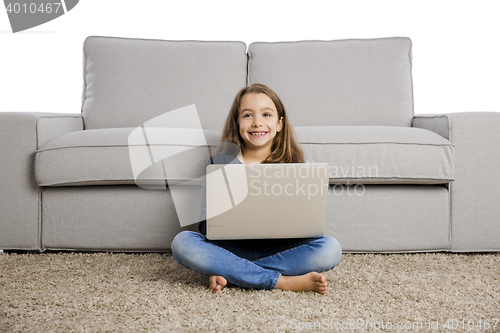 Image of Little girl working with a laptop