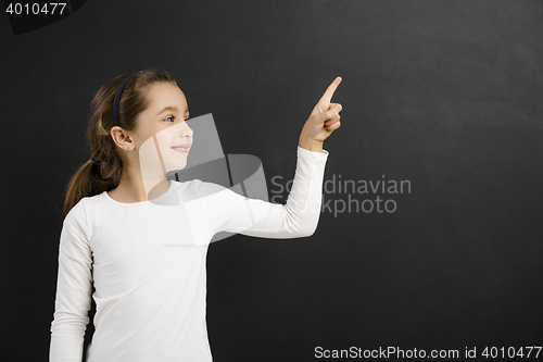 Image of Girl pointing to a blackboard