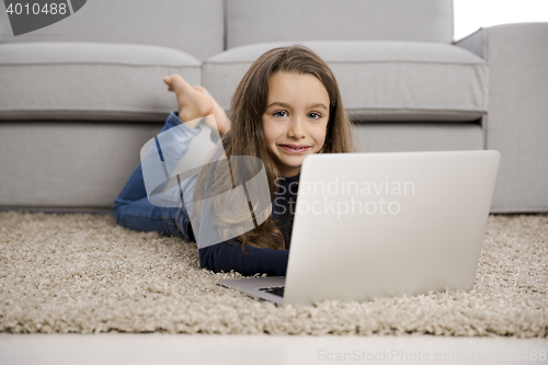Image of Little girl working with a laptop