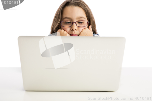 Image of Little girl working with a laptop