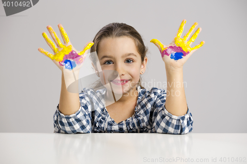 Image of Little girl with hands in paint