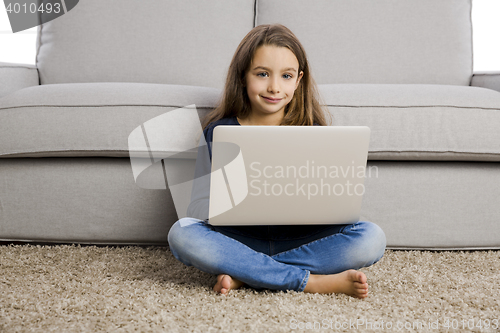 Image of Little girl working with a laptop