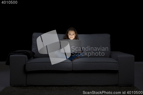 Image of Little girl working with a laptop
