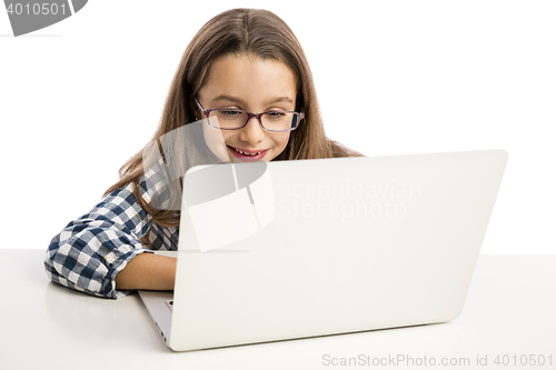 Image of Little girl working with a laptop
