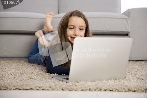 Image of Little girl working with a laptop