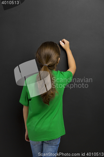 Image of Girl writing in a blackboard