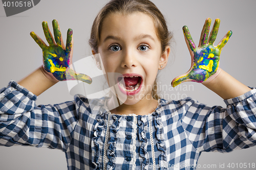 Image of Little girl with hands in paint