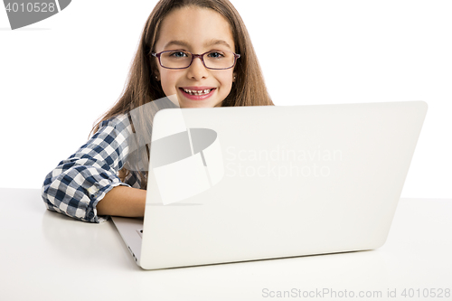 Image of Little girl working with a laptop