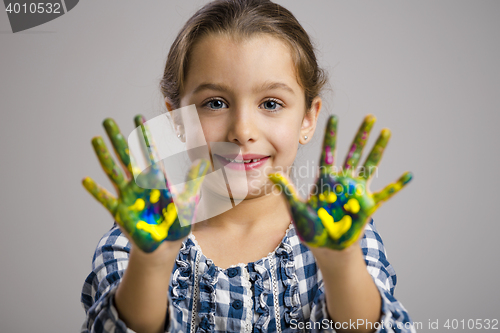 Image of Little girl with hands in paint