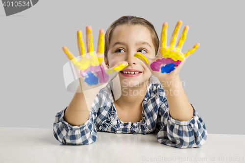 Image of Little girl with hands in paint