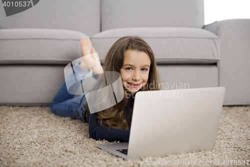 Image of Little girl working with a laptop