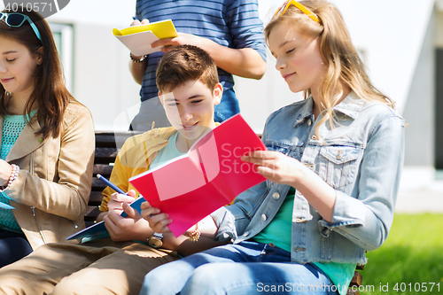 Image of group of students with notebooks at school yard