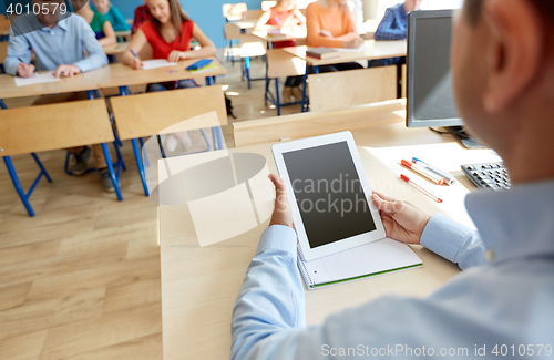 Image of students and teacher with tablet pc at school