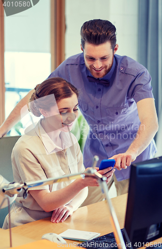 Image of business team with smartphone in office