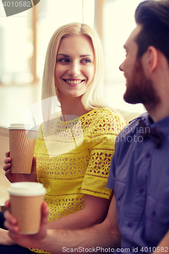 Image of happy man and woman drinking coffee in office