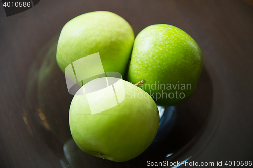 Image of close up of green apples on glass plate