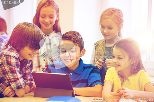 Image of group of school kids with tablet pc in classroom