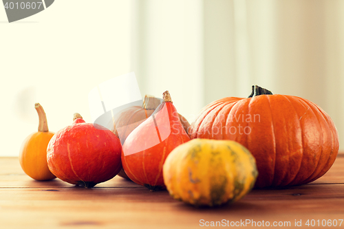 Image of close up of pumpkins on wooden table at home