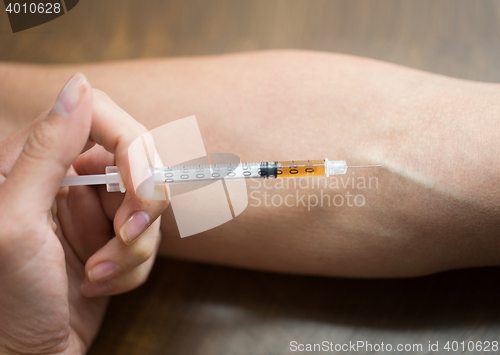 Image of close up of addict hand making drug injection