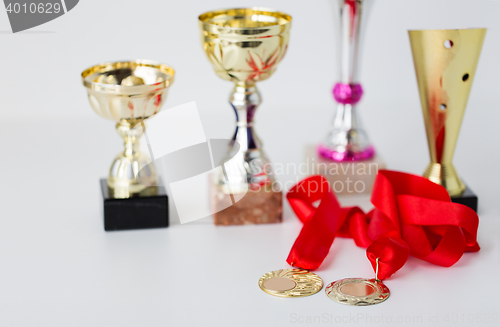 Image of close up of sports golden cups and medals