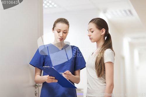 Image of doctor or nurse with clipboard and girl patient