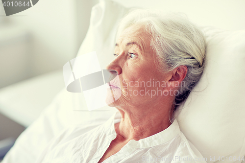 Image of senior woman patient lying in bed at hospital ward