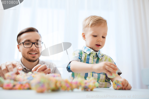 Image of father and son playing with ball clay at home