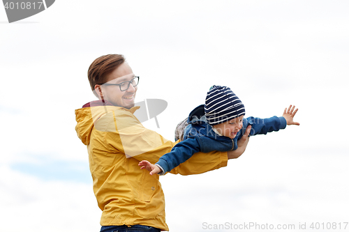 Image of father with son playing and having fun outdoors