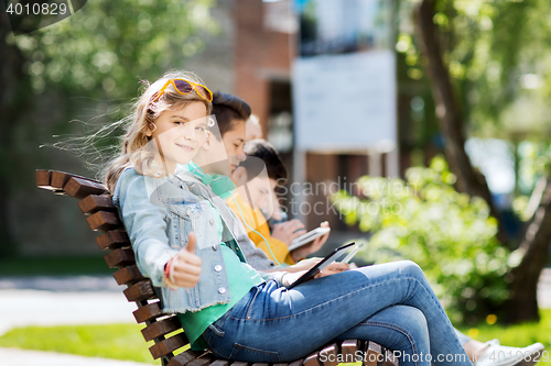 Image of happy girl with tablet pc computer outdoors