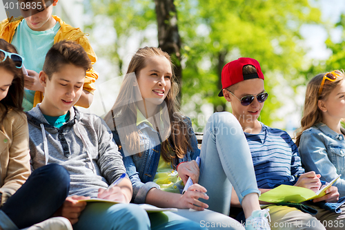 Image of group of students with notebooks at school yard