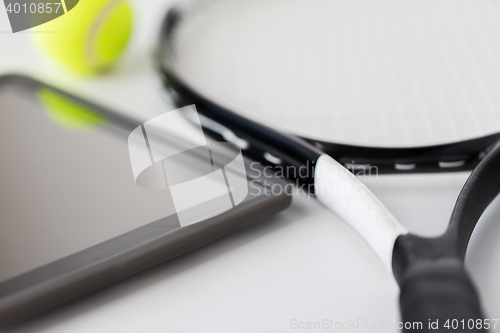 Image of close up of tennis racket with ball and tablet pc