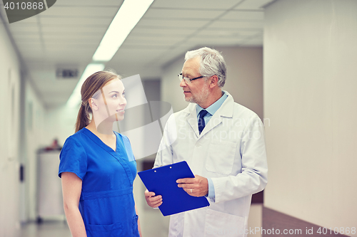 Image of senior doctor and nurse with tablet pc at hospital