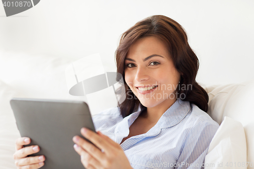 Image of smiling woman with tablet pc at home