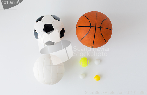 Image of close up of different sports balls set over white