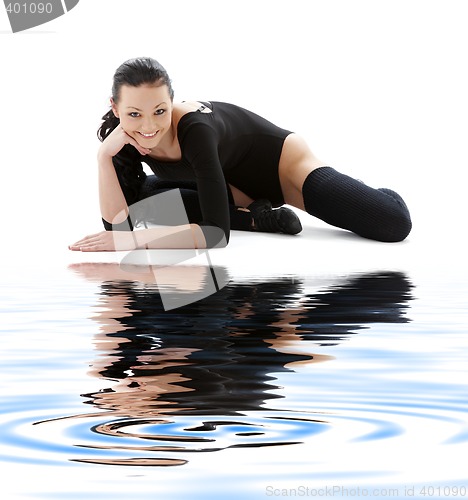 Image of sporty girl in black leotard on white sand