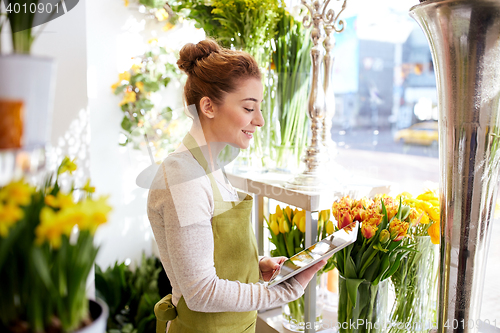 Image of woman with tablet pc computer at flower shop