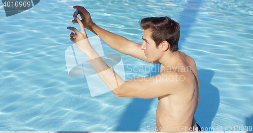 Image of Handsome muscular man takes photo of self