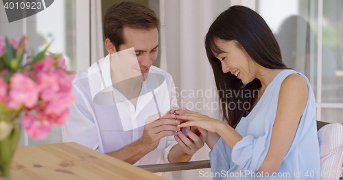 Image of Happy young woman accepting a wedding proposal