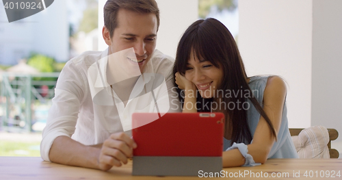 Image of Smiling couple using a tablet computer together