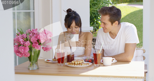 Image of Couple having breakfast at outdoor table