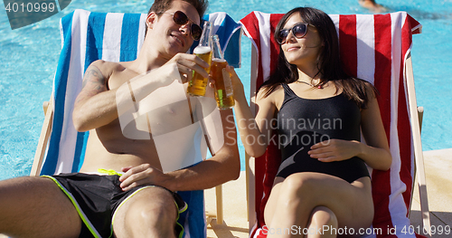 Image of Attractive young couple enjoying a beer